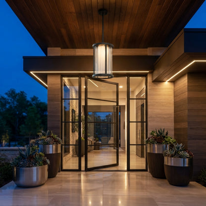 Cylinder Pendant Light - Black and Clear Weather Sealed Outdoor Pendant Casting a Warm Even Glow over Courtyard and Patio Gatherings